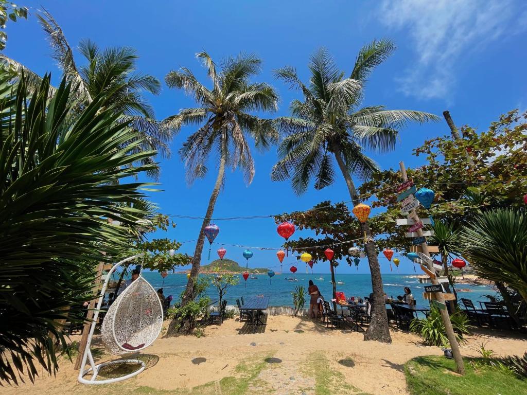 a beach with palm trees and a swing at Bãi Xếp Beach in Quy Nhon