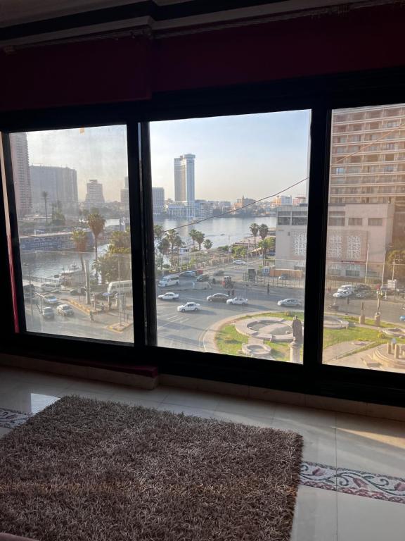 a room with a large window with a view of a city at شقة فندقية بانوراما علي النيل in Cairo