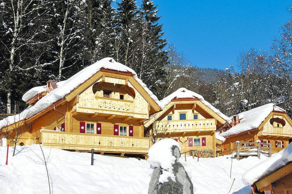 a large wooden house covered in snow at Chalet in Wildkogel near Ski Slopes & Pool in Neukirchen am Großvenediger
