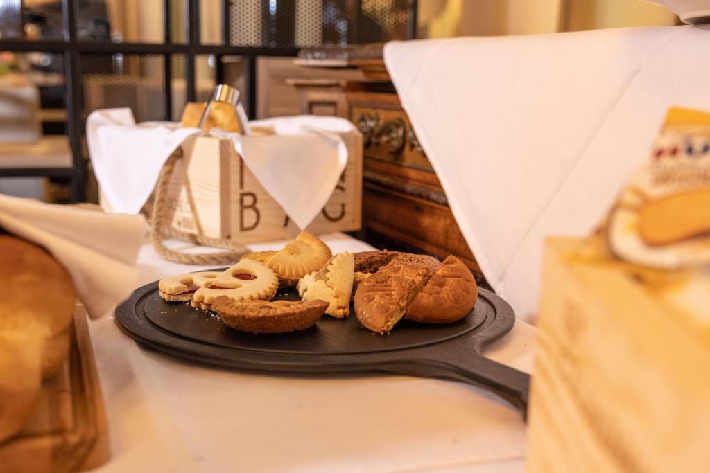 a plate of pastries on a table at Adhhoc Hotel in Naters