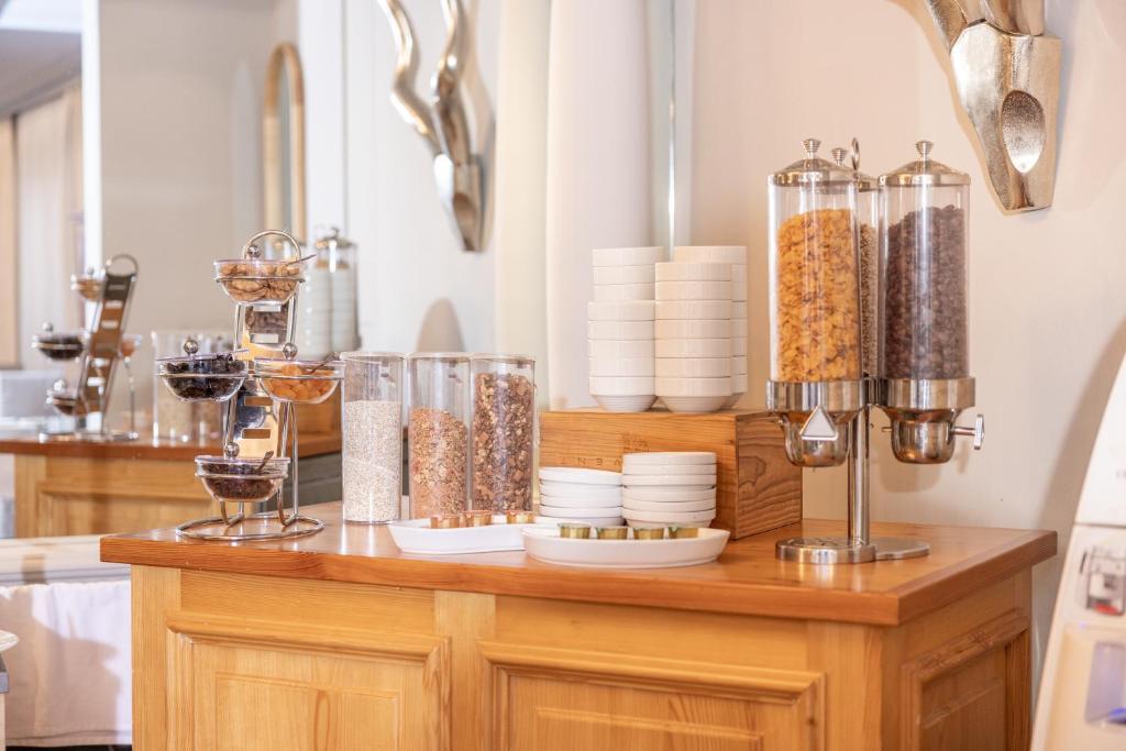a kitchen counter with bowls and containers of food at Adhhoc Hotel in Naters