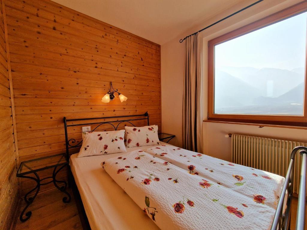 コルドラノにあるLangstein Bio Urlaub & Genussの木製の壁のベッドルーム1室(ベッド1台付)