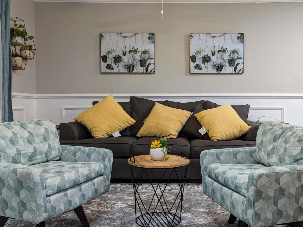 a living room with a couch and two chairs at Cute Apt near Atlanta Airport-9A in Atlanta