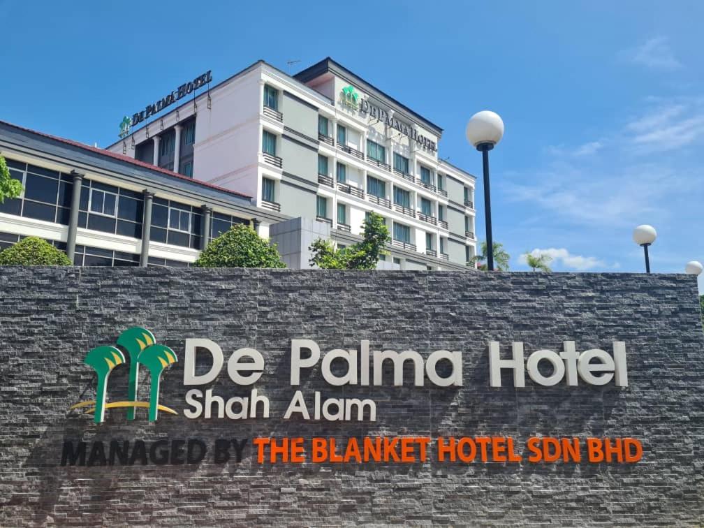 a sign for the palma hotel in front of a building at De Palma Hotel Shah Alam in Shah Alam