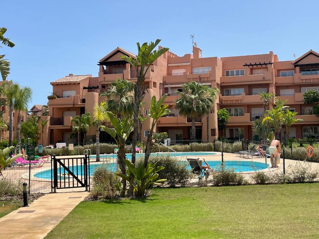 a large apartment complex with a swimming pool in front of a building at Spirit of Mar Menor in Torre-Pacheco