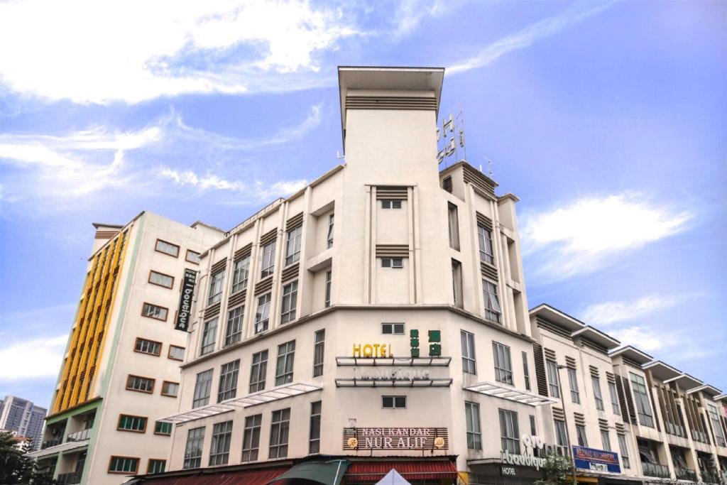 a white building with a tower on top of it at Super OYO 331 I Boutique Hotel in Petaling Jaya
