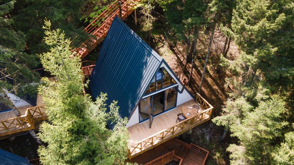 a blue roofed bus on a bridge in a forest at Montana Suite Bungalows in Akcaabat