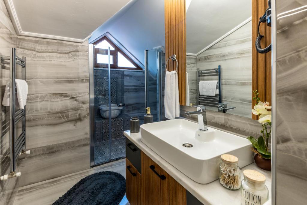 a bathroom with a sink and a shower at Baymari Suites Design Florya in Istanbul