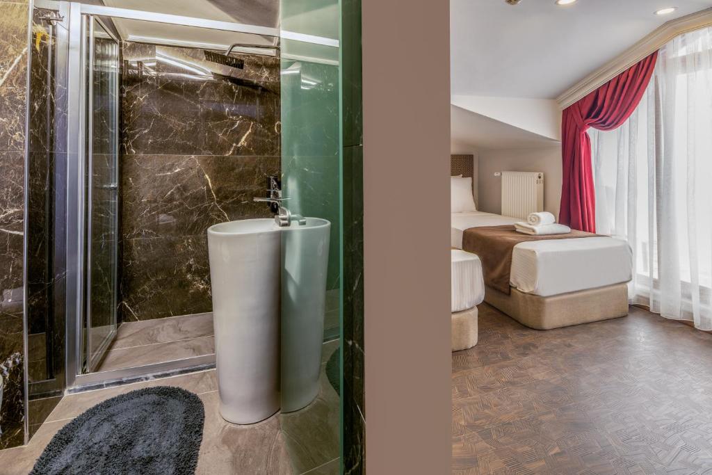 a bathroom with a shower and a tub in a room at Baymari Suites Design Florya in Istanbul