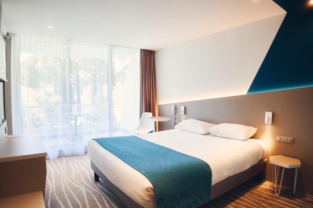 Postel nebo postele na pokoji v ubytování Hotel Le Quetzal