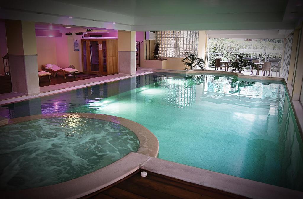 a large swimming pool in a hotel room at Admiral Hotel Villa Erme in Desenzano del Garda
