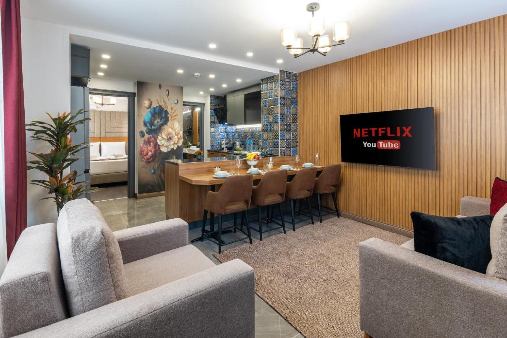 a dining room and kitchen with a table and chairs at Baymari Suites Design Florya in Istanbul