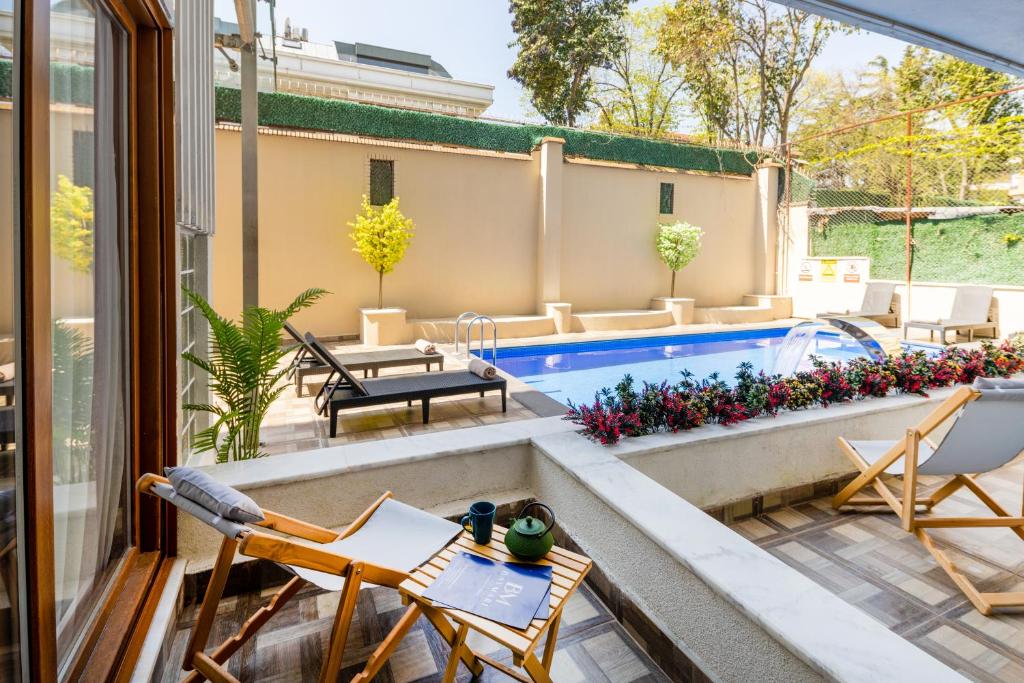 a patio with chairs and a swimming pool at Baymari Suites Design Florya in Istanbul