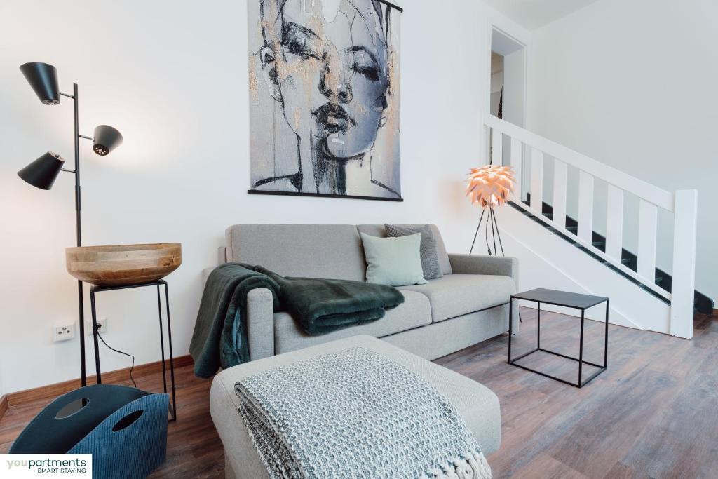 a living room with a couch and a table at Aasee Apartment in top Lage 80m² mit 2 Schlafzimmern in Münster