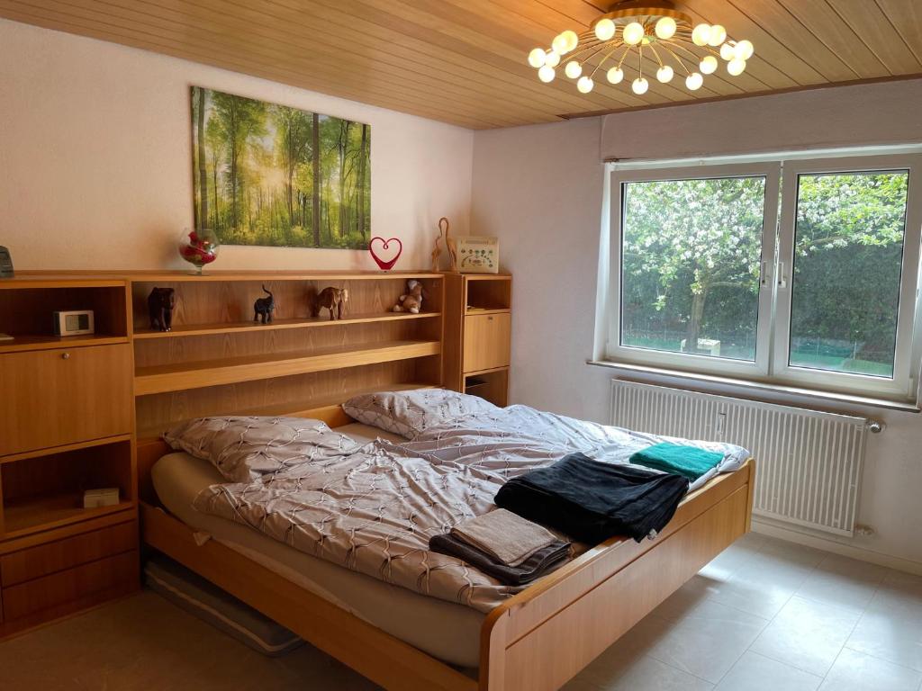 a bedroom with a bed and a large window at Sehr schöne Wohnung in 70839 Gerlingen in Deutschland in Gerlingen