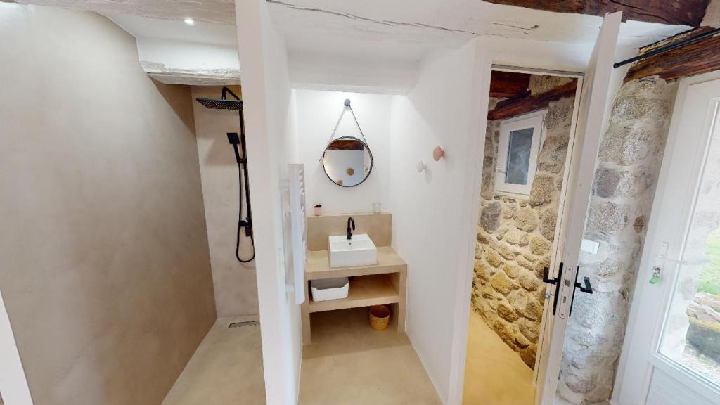 a bathroom with a sink and a mirror on the wall at Une pause en Corrèze in Sarroux