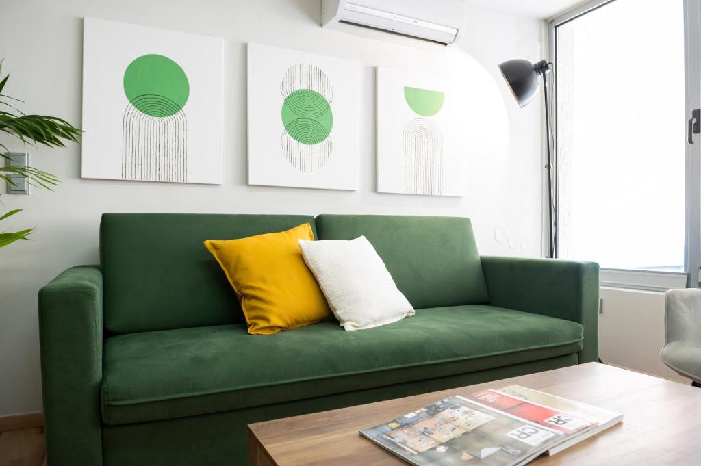 a green couch in a living room with a table at Urban Downtown Suite Xanthi - MenoHomes 4 in Xanthi