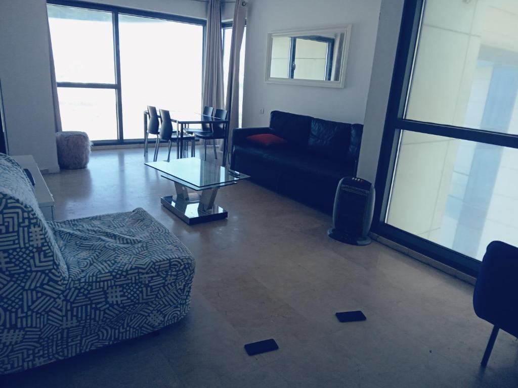 a living room with a couch and a table at דירות נופש מרינה הרצליה in Herzliya B
