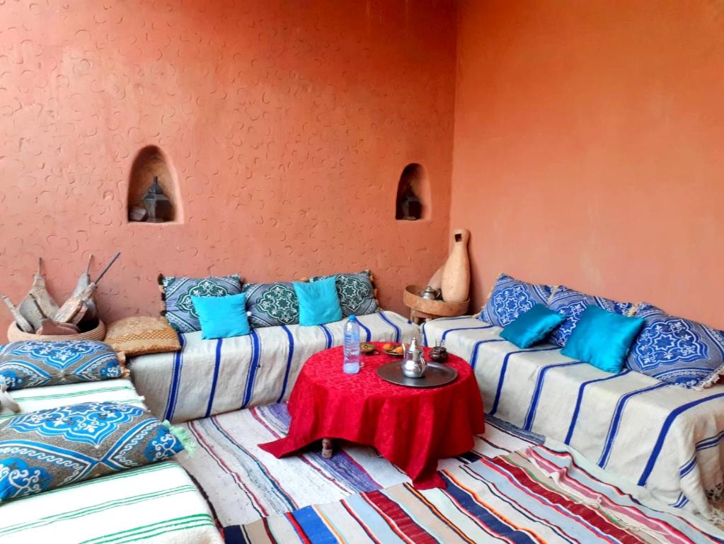 a living room with two couches and a table at LA PETITE MAISON DU LAC IRIKI in Foum Zguid