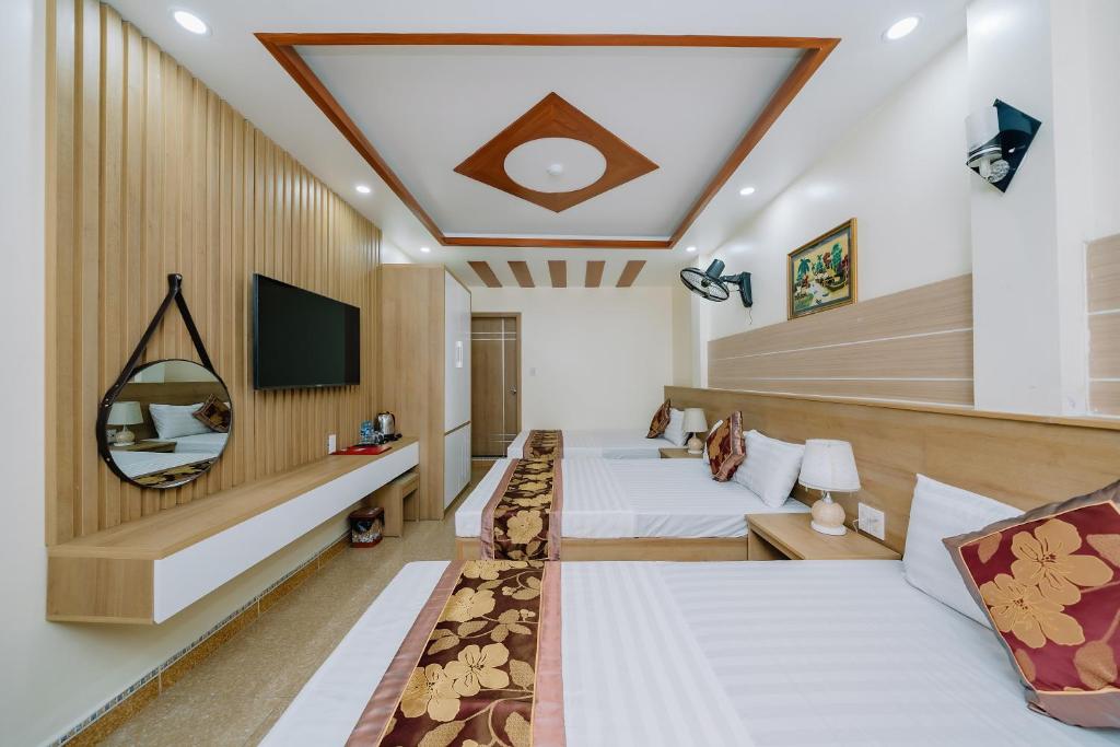 Habitación de hotel con 2 camas y TV en My Ngoc Hotel, en Cat Ba