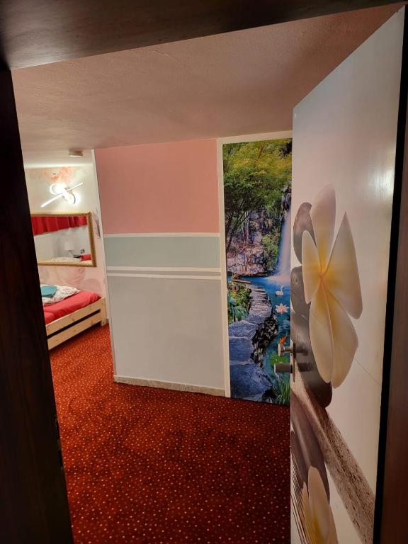 a room with a door with a painting on the wall at Hostel Hamburg in Hamburg