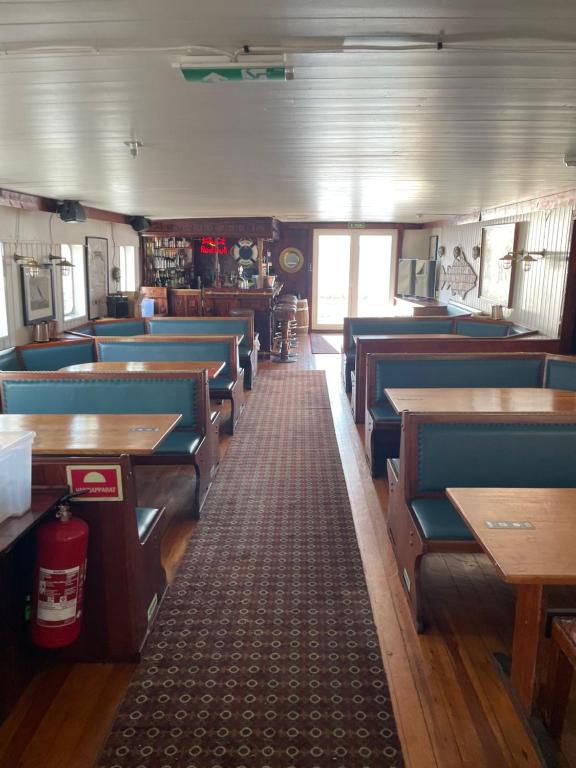 a dining room with blue chairs and tables at Showboat in Bergen