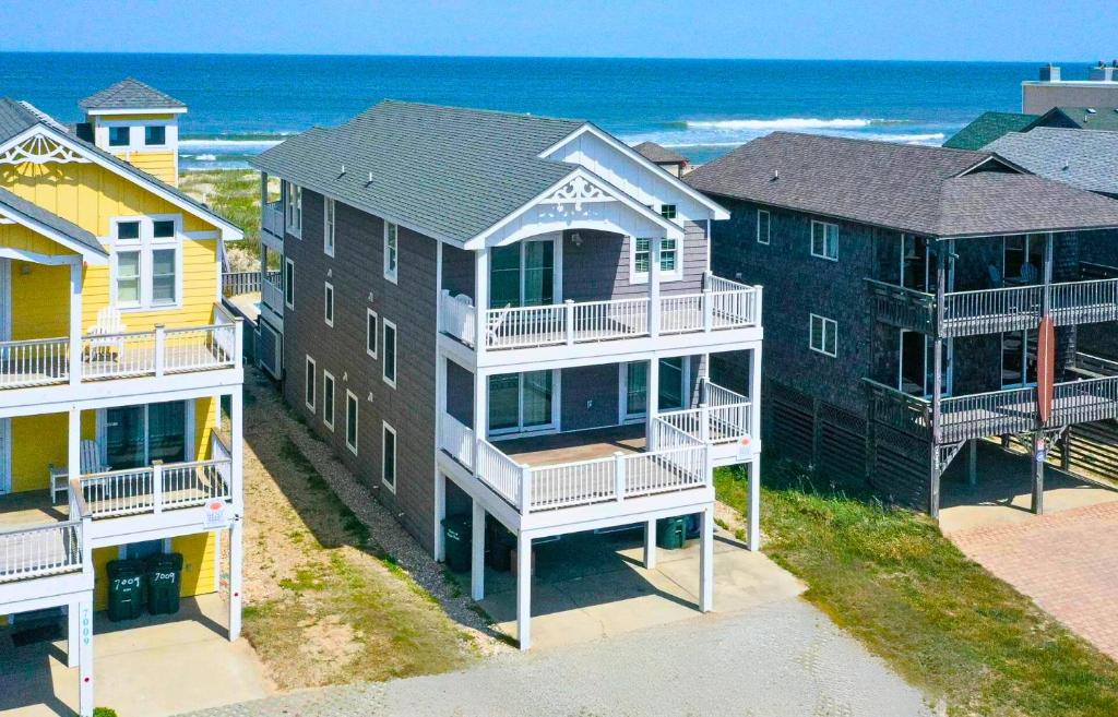 an aerial view of houses on the beach at Hidden Treasure - Nags Head MP 16, Oceanfront, Private Beach Access, Pool, Hot Tub, Pool Table, Pets OK in Nags Head