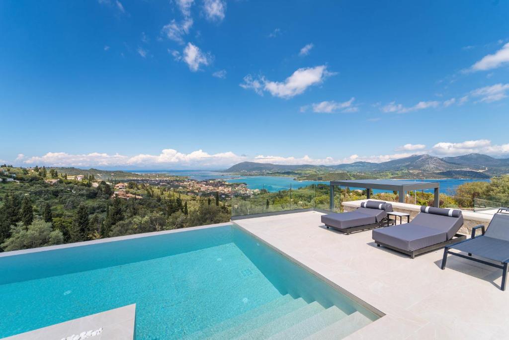 a villa with a swimming pool and a view at Dama Olga Villas in Lygia