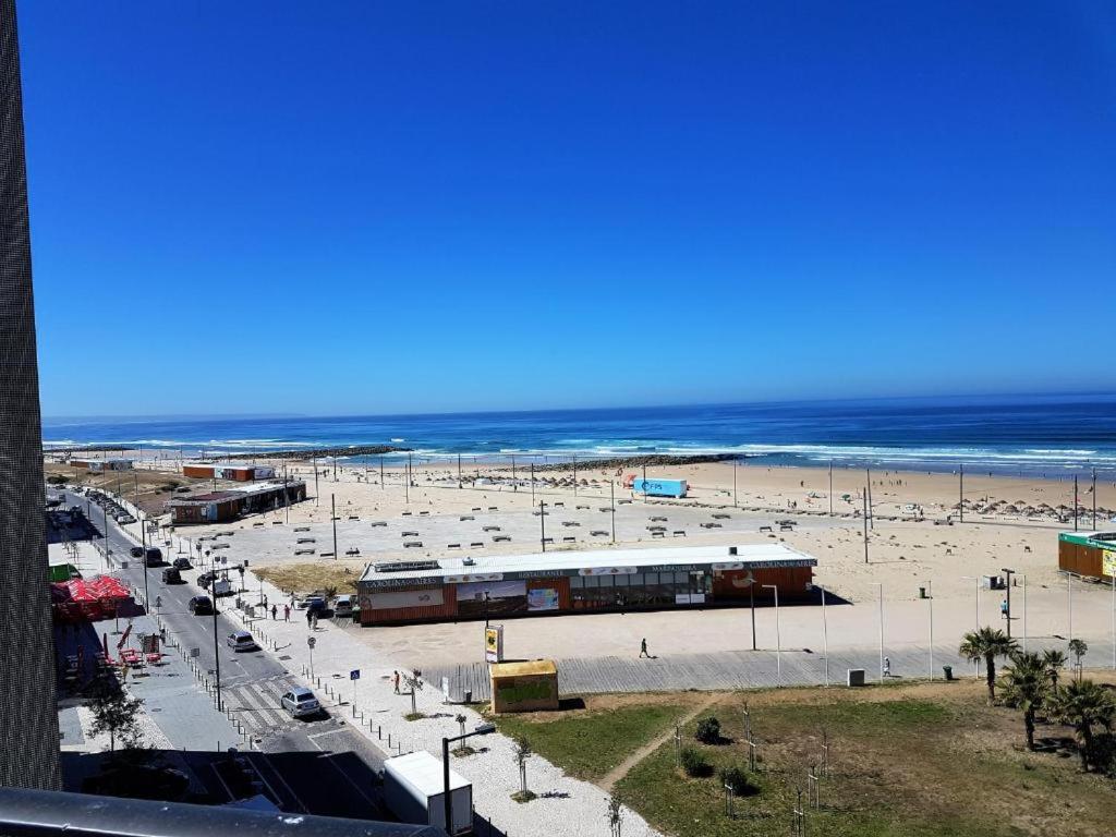 a view of a beach with the ocean in the background at Costa by the Beach in Costa da Caparica
