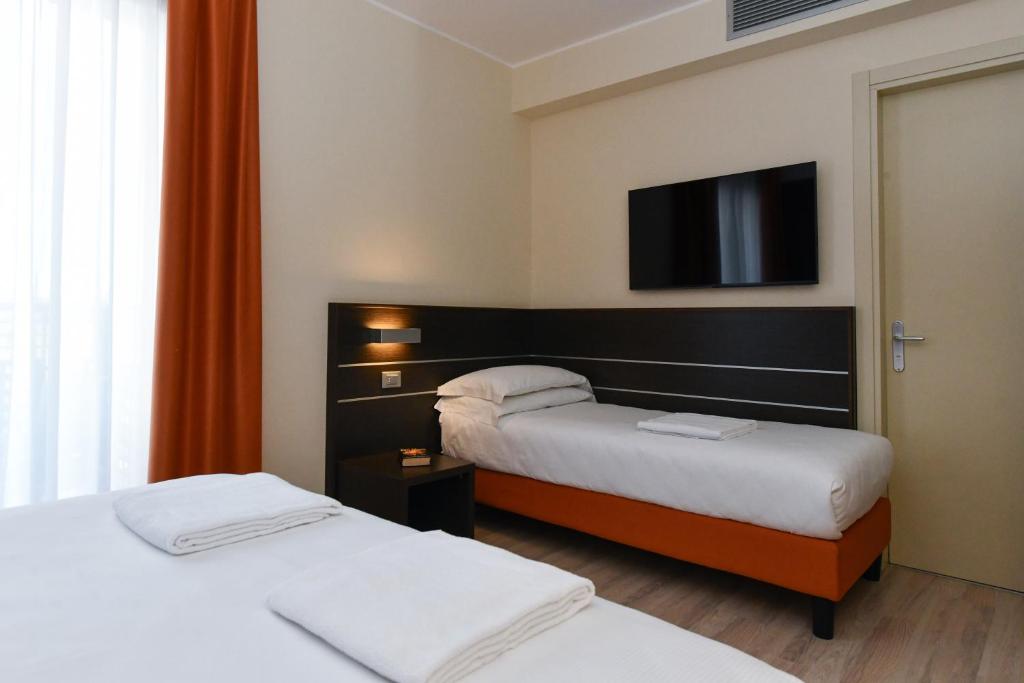 Posteľ alebo postele v izbe v ubytovaní Hotel Vienna