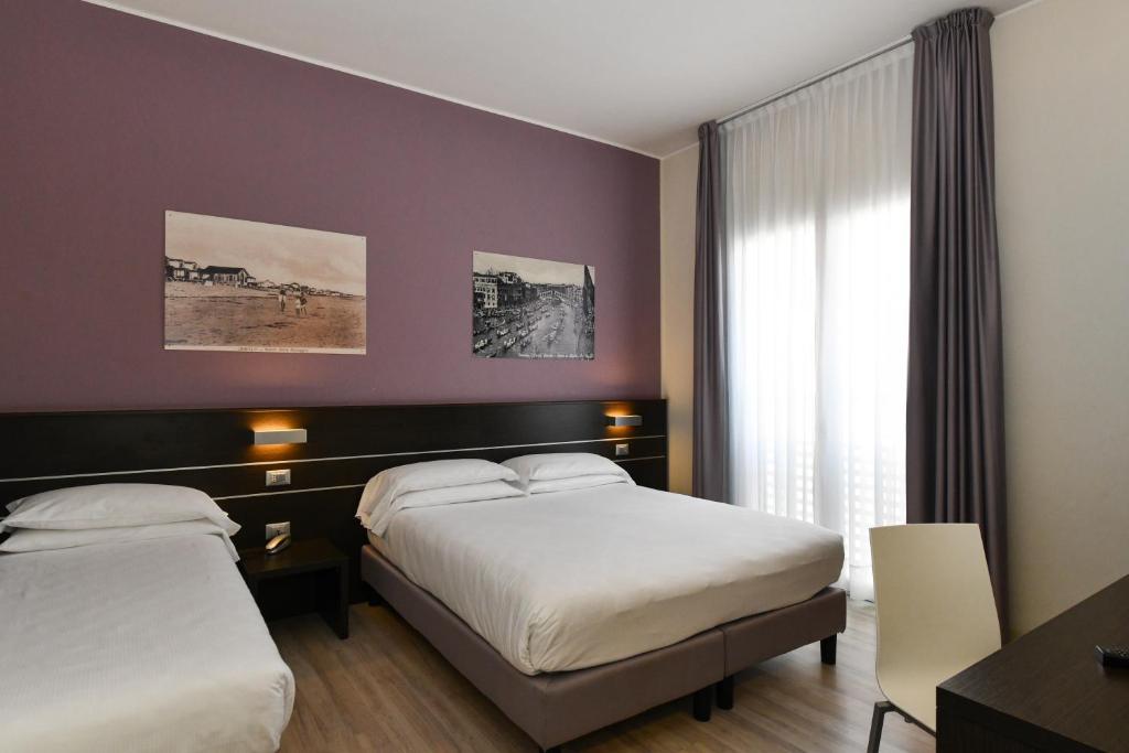 Posteľ alebo postele v izbe v ubytovaní Hotel Vienna