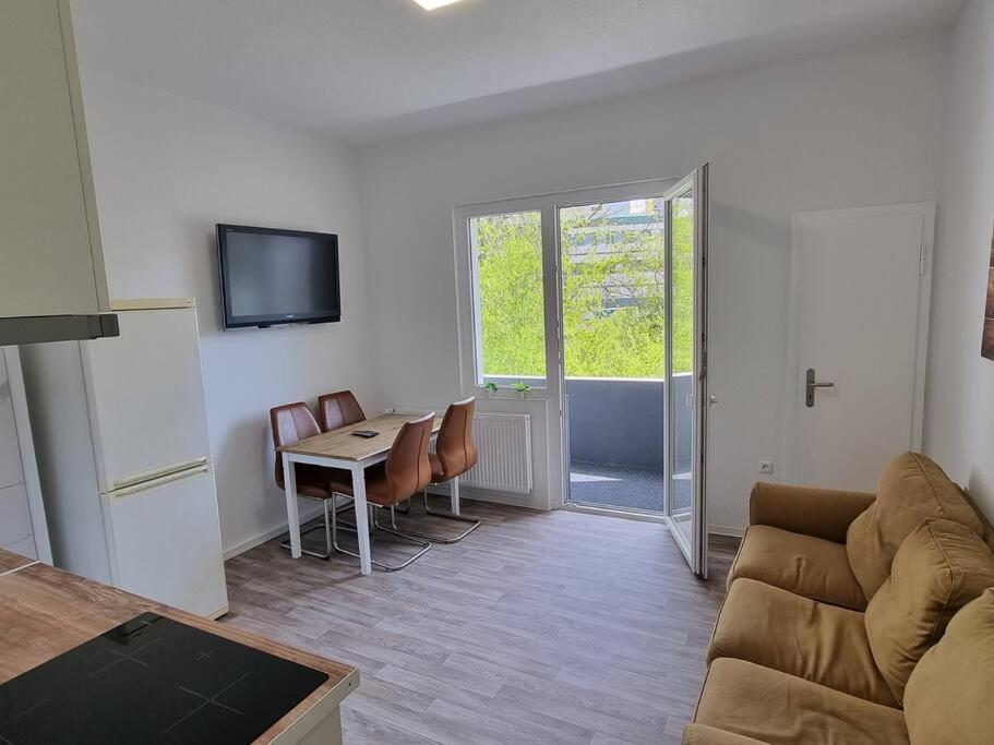 a living room with a couch and a table with chairs at Viktoria's Appartment in OB-Mitte in Oberhausen