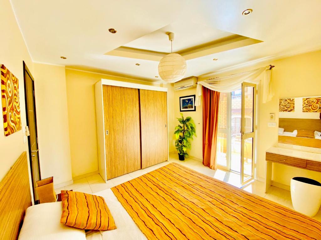 A bed or beds in a room at Panda Grey with balcony Hurghada center