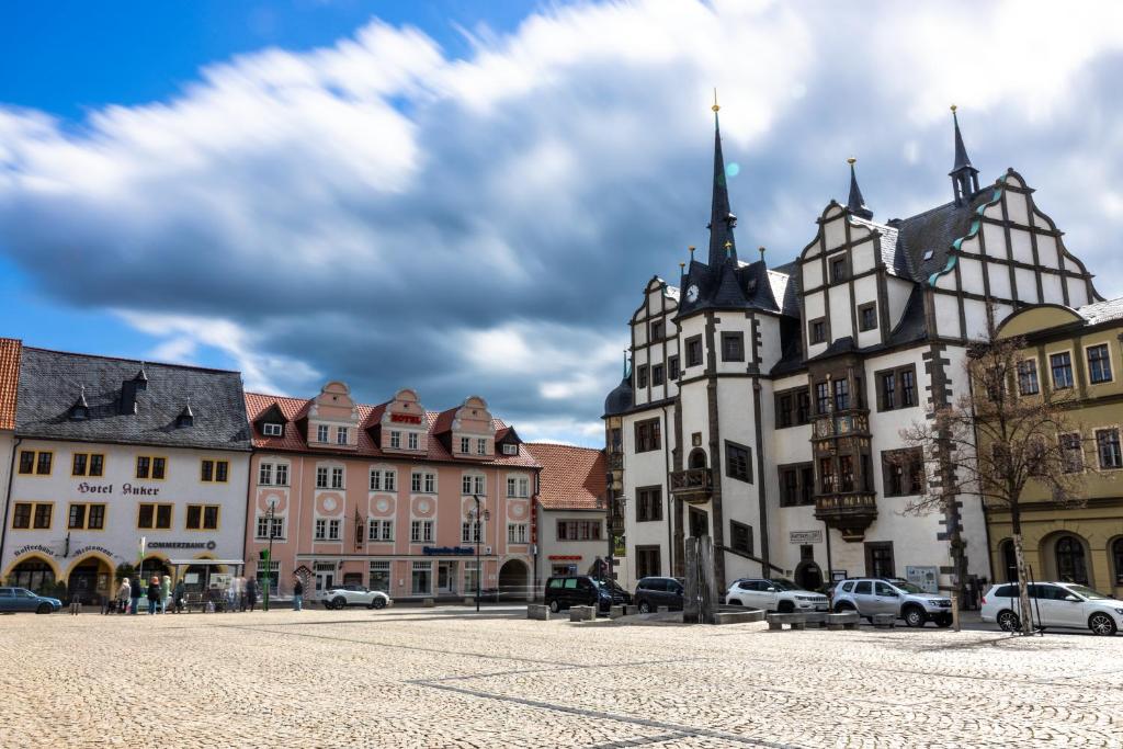 a group of buildings on a street in a town at Hotel Anker in Saalfeld