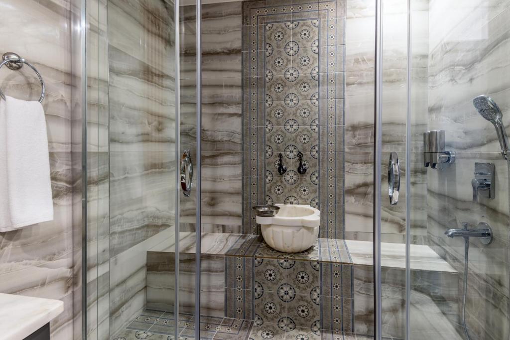 a bathroom with a shower with a glass door at Baymari Suites Design Florya in Istanbul