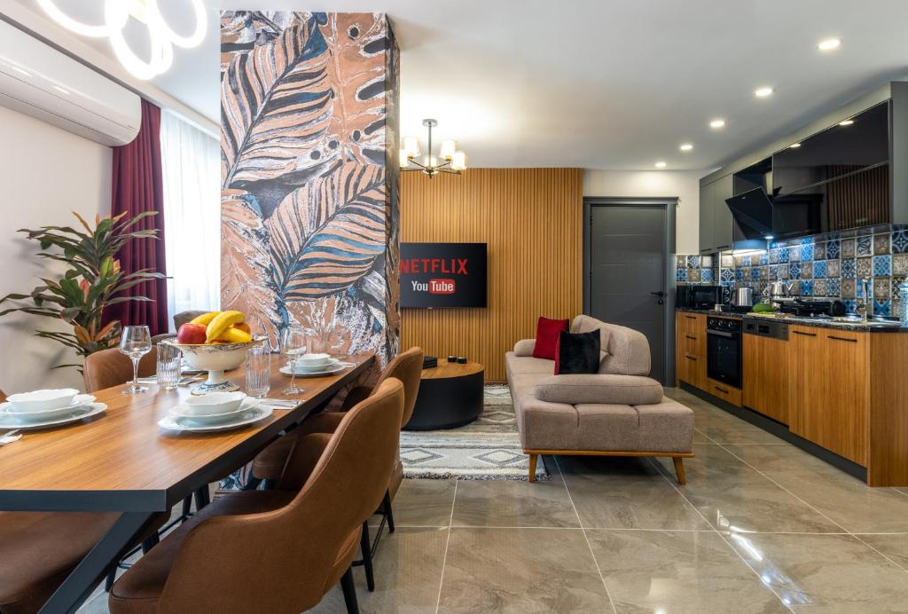 a dining room with a table and chairs and a kitchen at Baymari Suites Design Florya in Istanbul