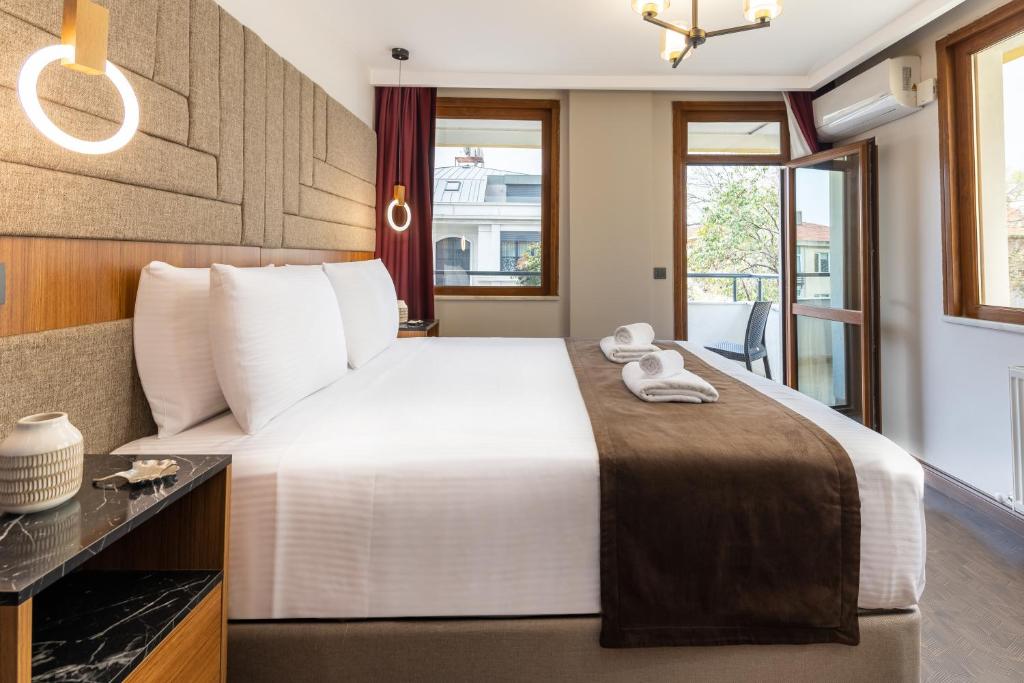 a hotel room with a large bed and a window at Baymari Suites Design Florya in Istanbul