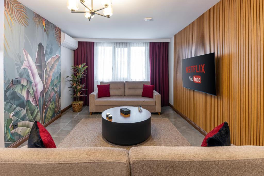 a living room with a couch and a table at Baymari Suites Design Florya in Istanbul