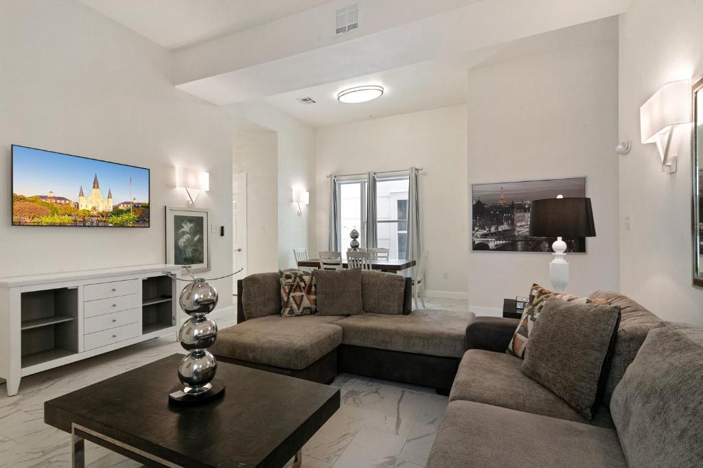 a living room with a couch and a table at Breathtaking Condos Near French Quarter in New Orleans