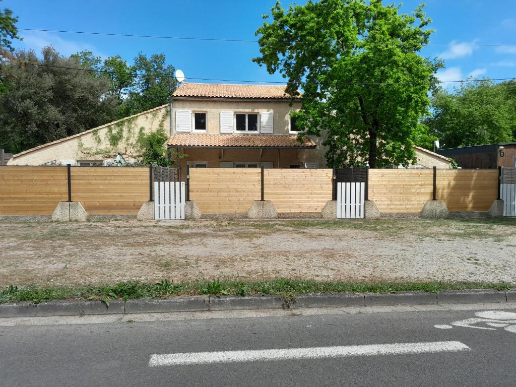 ein Haus mit einem Zaun am Straßenrand in der Unterkunft Appartement SOULAC SUR MER À 500 m de la plage N 3 in Soulac-sur-Mer