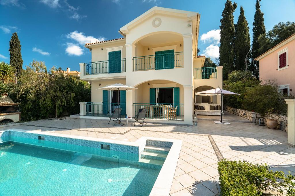 a villa with a swimming pool and a house at Villa Millianna - Ground Floor Apt in Kefallonia