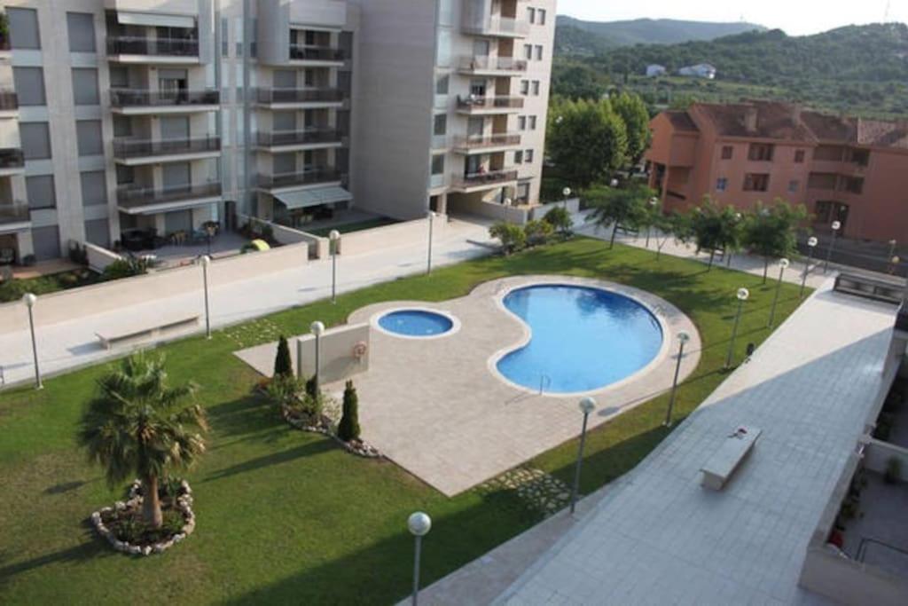 an overhead view of a swimming pool in a city at New Apartment 800m from the beach + pool + garage in Calafell
