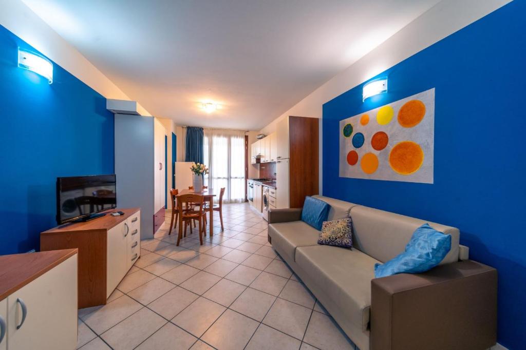 a living room with a couch and a tv at Residence Alessandra in Cesenatico