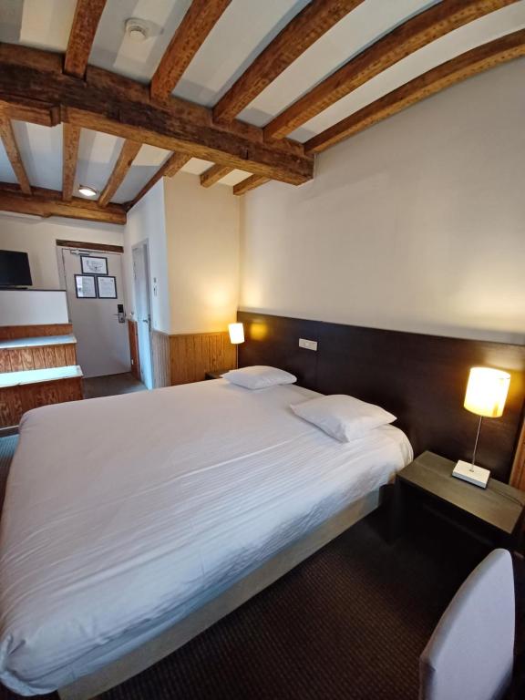 Postel nebo postele na pokoji v ubytování Hotel Koffieboontje