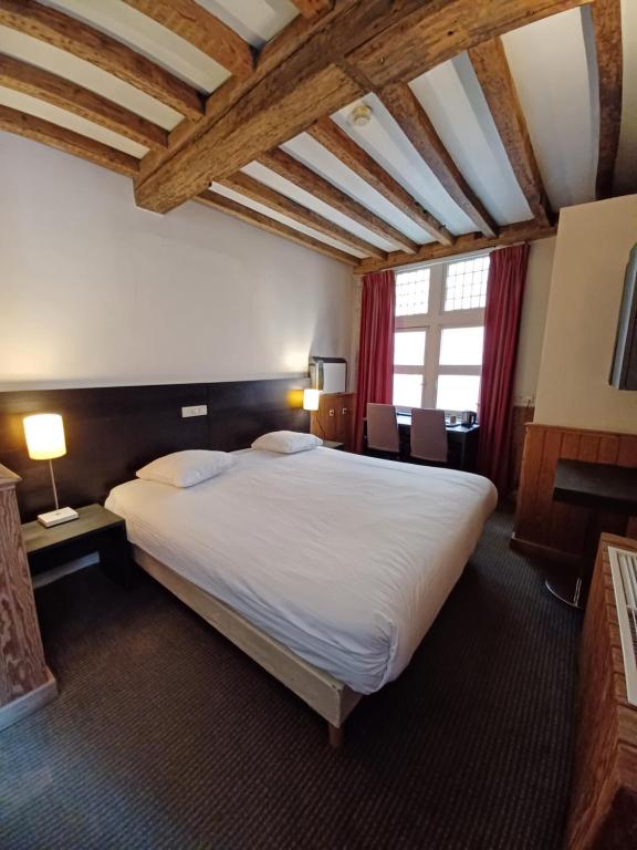 Postel nebo postele na pokoji v ubytování Hotel Koffieboontje