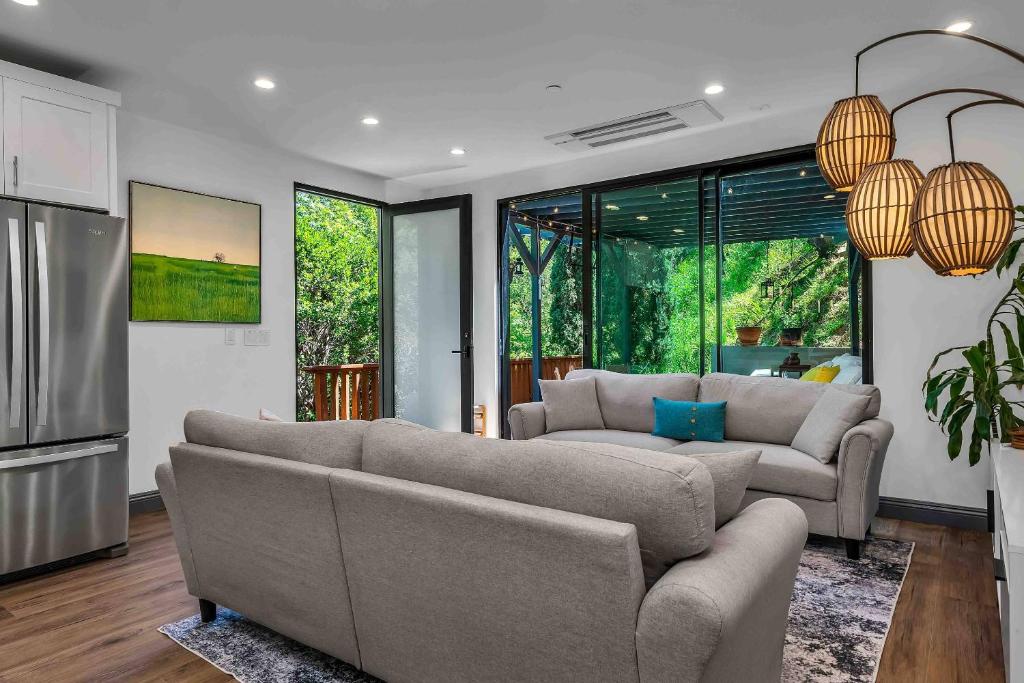 uma sala de estar com dois sofás e uma cozinha em Glen Oak Bungalow em Los Angeles