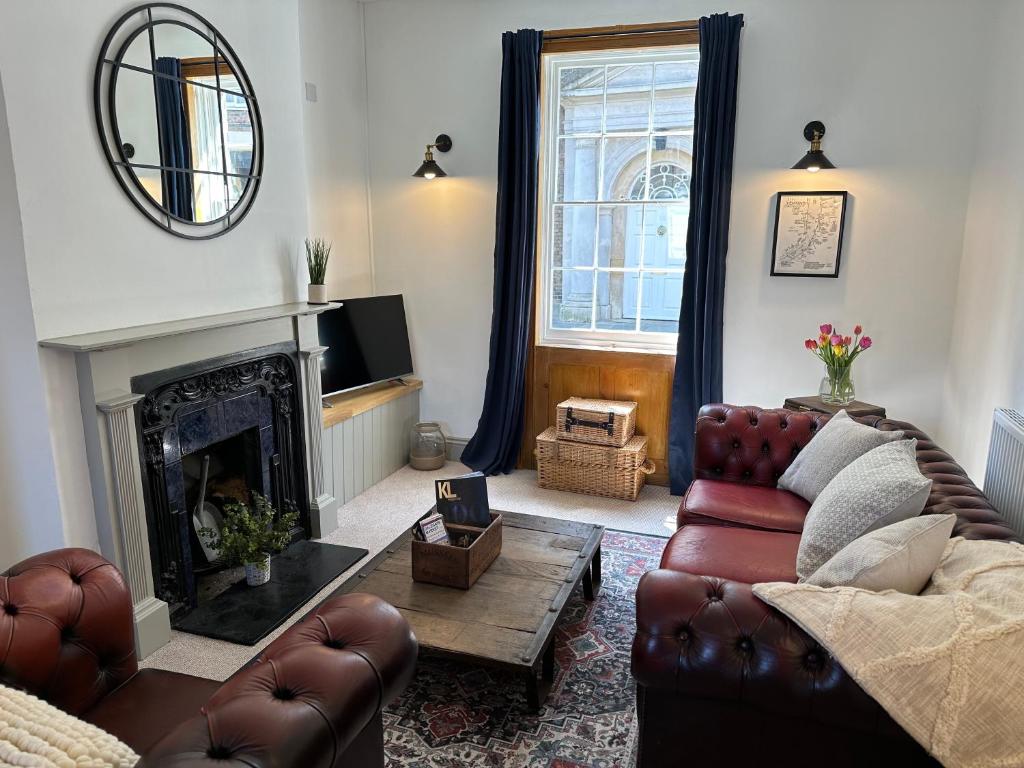 a living room with a couch and a fireplace at Quayside Georgian Townhouse in Kings Lynn