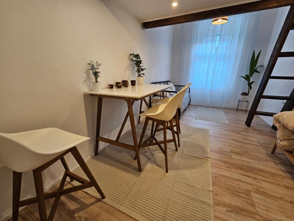 a dining room with a table and chairs and a ladder at surf.Lend in Graz