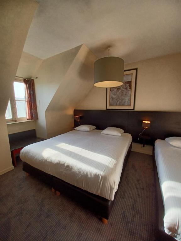 Postel nebo postele na pokoji v ubytování Hotel Koffieboontje
