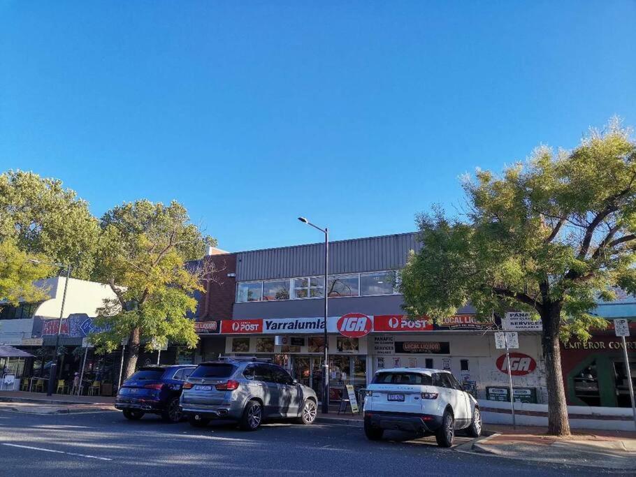 a group of cars parked in front of a store at Parliament Triangle * Garden View in Yarralumla